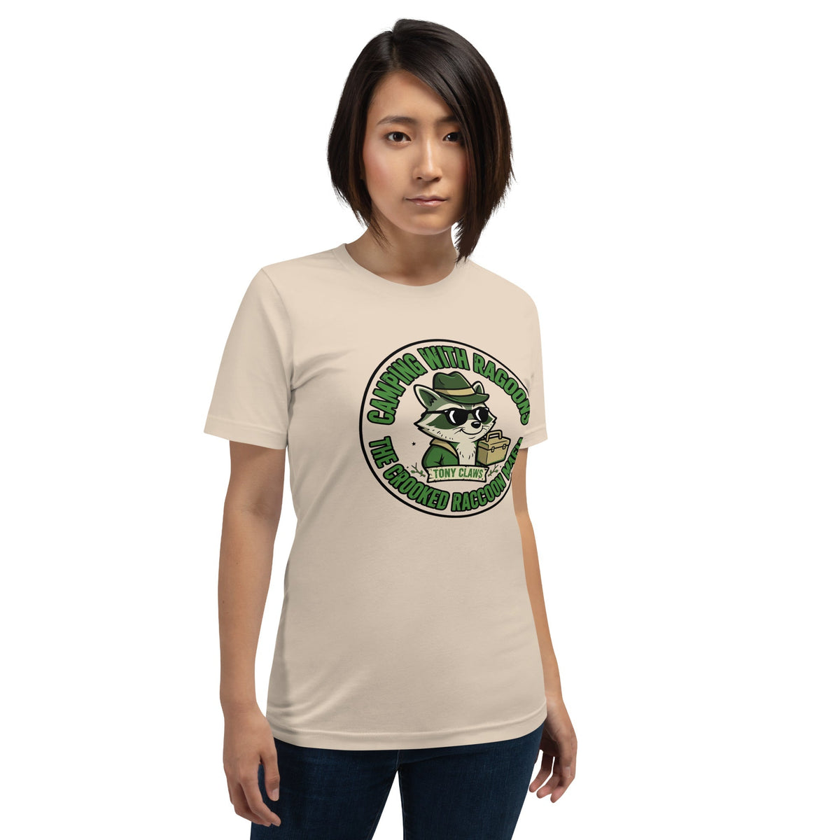 Model wearing a cream T-shirt with a green Camping With RAGOONS raccoon graphic